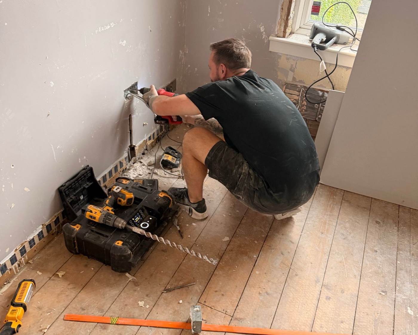 Gary from 17 Electrical fitting new sockets during a full rewire